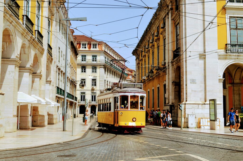 Alfama district with colourful tiled buildings and a tram