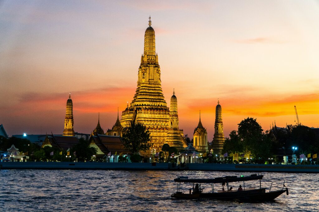 Wat Arun temple at sunset from the Chao Phraya river